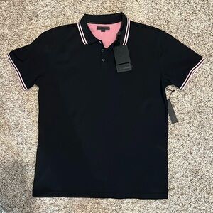 Soft black colored golf shirt with pink and white stripes.